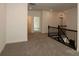 Spacious loft area featuring neutral carpeting and dark railing with open hallway and doorway at 1136 Yellow Springs Dr, Huntersville, NC 28078