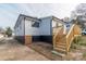 Home's exterior with new siding, deck, and stairs at 117 Falls Rd, Badin, NC 28009