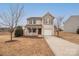 Two-story house with beige vinyl siding, brown door, and attached garage at 1178 Valley St, Statesville, NC 28677