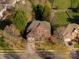Aerial view of a large house with a well-kept lawn and mature landscaping at 11805 Farnborough Rd, Huntersville, NC 28078
