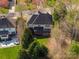Aerial view of a house with a back porch, green lawn, and trees at 11805 Farnborough Rd, Huntersville, NC 28078
