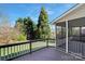 An inviting outdoor deck with screen door and a view of a lush green yard at 11805 Farnborough Rd, Huntersville, NC 28078