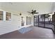 The back porch features a patterned rug, an outdoor ceiling fan, and a screen door at 11805 Farnborough Rd, Huntersville, NC 28078
