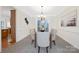 Elegant dining room with a modern chandelier, neutral paint, and plush carpeting at 11805 Farnborough Rd, Huntersville, NC 28078