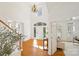 Spacious foyer with gleaming hardwood floors, high ceilings, and elegant staircase at 11805 Farnborough Rd, Huntersville, NC 28078