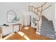 Bright foyer with hardwood floors, staircase, and stylish decor creates a welcoming entrance at 11805 Farnborough Rd, Huntersville, NC 28078