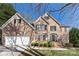 Beautiful two-story brick home with a manicured lawn and attached two-car garage at 11805 Farnborough Rd, Huntersville, NC 28078