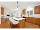 Modern kitchen with a large island, white countertops, and wood cabinets at 11805 Farnborough Rd, Huntersville, NC 28078
