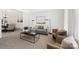 Cozy living room with plush seating, modern decor, and natural light with dining in the background at 11805 Farnborough Rd, Huntersville, NC 28078
