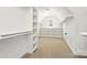 Large walk-in closet featuring extensive shelving and ample storage space at 11805 Farnborough Rd, Huntersville, NC 28078