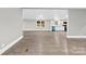 Open living room and kitchen with wood floors at 1515 Sugarcane Ln, Gastonia, NC 28056