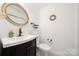 Clean and updated half bathroom with a pedestal sink and toilet at 204 Riverview Ter, Lake Wylie, SC 29710