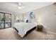 Bright bedroom with a ceiling fan and sliding glass doors to the outside at 204 Riverview Ter, Lake Wylie, SC 29710