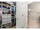A walk-in closet with white shelves and racks, adjacent to the bathroom at 204 Riverview Ter, Lake Wylie, SC 29710