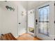 Welcoming entryway featuring a decorative glass door and white paneled walls with warm hardwood flooring at 204 Riverview Ter, Lake Wylie, SC 29710