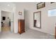 Hallway with tan walls, carpet, and a dresser, illuminated by natural light at 204 Riverview Ter, Lake Wylie, SC 29710