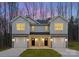 Two-story duplex home with attached garages and landscaping at 2113 Gemway Dr, Charlotte, NC 28216