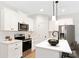 Modern kitchen with white cabinets, stainless steel appliances, and an island at 2113 Gemway Dr, Charlotte, NC 28216