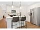 Modern kitchen with white cabinets and island seating at 2113 Gemway Dr, Charlotte, NC 28216