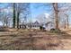 House exterior view, large backyard, mature trees at 217 E Old Highway 74 Hwy # 4, Monroe, NC 28112