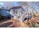 Rear view of charming blue house, showcasing deck and backyard at 217 E Old Highway 74 Hwy # 4, Monroe, NC 28112