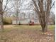 Tan single wide mobile home with trees in the background at 2345 Kingsburry Rd, York, SC 29745