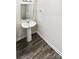 Simple pedestal sink and mirror in small bathroom with wood-look floors at 241 Century Dr, Salisbury, NC 28147