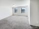 Bright carpeted bedroom with neutral walls and two windows at 241 Century Dr, Salisbury, NC 28147