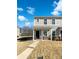Two-story townhome with gray siding, brick accents and a front porch at 241 Century Dr, Salisbury, NC 28147