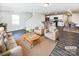 Open living room and kitchen with hardwood floors and neutral decor at 241 Century Dr, Salisbury, NC 28147