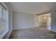 Living room features neutral walls and carpeted floors at 2606 Park Rd # C, Charlotte, NC 28209