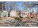 Tan mobile home with orange shutters and wooden deck at 311 Chase Dr, Iron Station, NC 28080