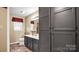 Bathroom with dark gray cabinets and a large mirror at 50 Berea Church Quincy Rd, Hiddenite, NC 28636