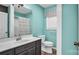 Teal bathroom with a toilet, shower, and dark vanity at 50 Berea Church Quincy Rd, Hiddenite, NC 28636
