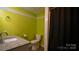 Basement bathroom with lime green walls and shower/tub combo at 50 Berea Church Quincy Rd, Hiddenite, NC 28636