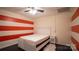 Charming basement bedroom with red and white striped wall at 50 Berea Church Quincy Rd, Hiddenite, NC 28636
