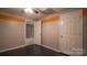 Basement bedroom with an orange accent wall and ceiling fan at 50 Berea Church Quincy Rd, Hiddenite, NC 28636