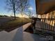 Inviting front porch with sunset view and stone accents at 50 Berea Church Quincy Rd, Hiddenite, NC 28636