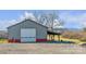 Large metal garage with a covered carport at 50 Berea Church Quincy Rd, Hiddenite, NC 28636