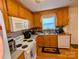 Kitchen with wood cabinets, white appliances, and hardwood floors at 5001 Roseboro Ct # D, Lowell, NC 28098