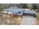 Gray house with a deck and carport, nestled in a wooded area at 5020 Foster Rd, Cleveland, NC 27013