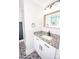 A renovated bathroom with a granite countertop, patterned tile flooring, and new lighting at 5020 Foster Rd, Cleveland, NC 27013
