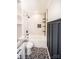 This is a bathroom with a bathtub, black fixtures, and white tile, featuring a black and white floor at 5020 Foster Rd, Cleveland, NC 27013