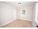 Cozy bedroom with neutral carpet, a window, and white trim at 5020 Foster Rd, Cleveland, NC 27013