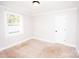 This is a bedroom with light-colored walls, and light carpet, and a large window at 5020 Foster Rd, Cleveland, NC 27013