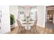 Cozy dining area featuring a round glass table with seating for four near sunlit windows at 5020 Foster Rd, Cleveland, NC 27013