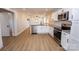 Bright, remodeled kitchen featuring white cabinets, granite countertops, and stainless steel appliances at 5020 Foster Rd, Cleveland, NC 27013