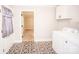 Laundry room featuring patterned tile floors, modern appliances, and built-in shelving at 5020 Foster Rd, Cleveland, NC 27013