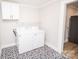 A laundry room with patterned tile floors, modern appliances, and built-in shelving at 5020 Foster Rd, Cleveland, NC 27013