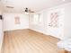 Living room with hardwood floors, ceiling fan, and access to the front porch at 5020 Foster Rd, Cleveland, NC 27013
